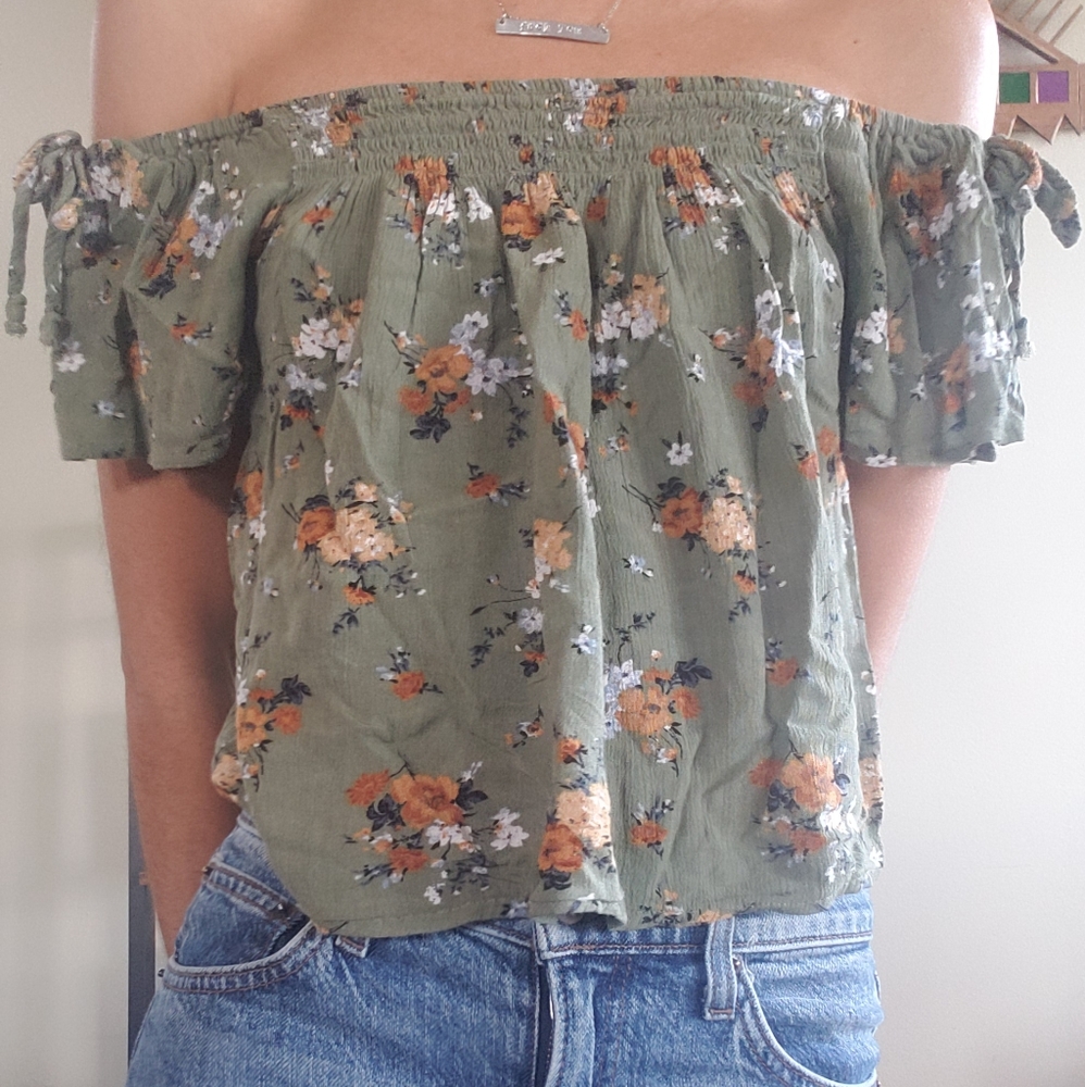 Off-shoulder floral shirt.